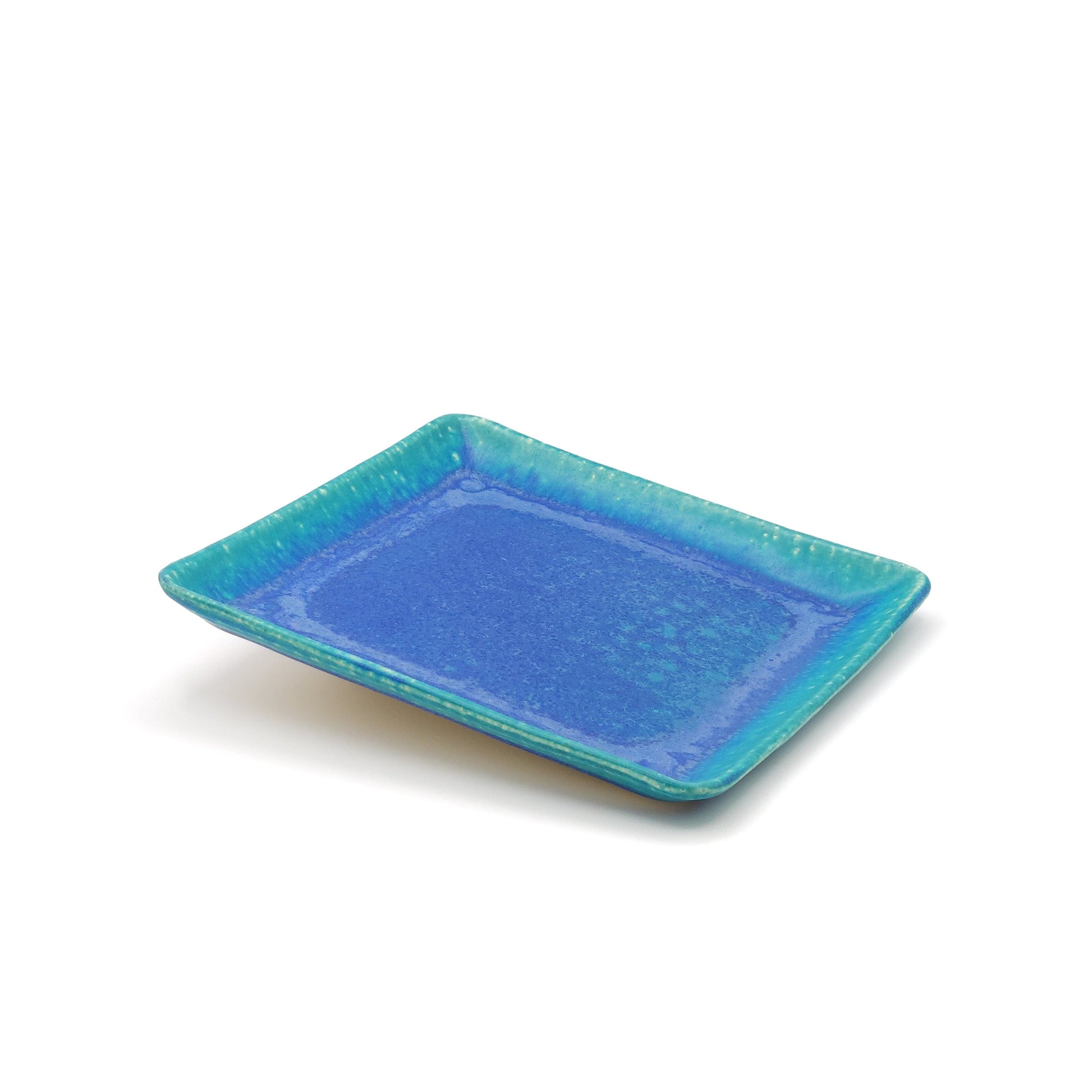 View of a lifted turquoise Japanese pottery plate measuring 21.5cm (8.5")