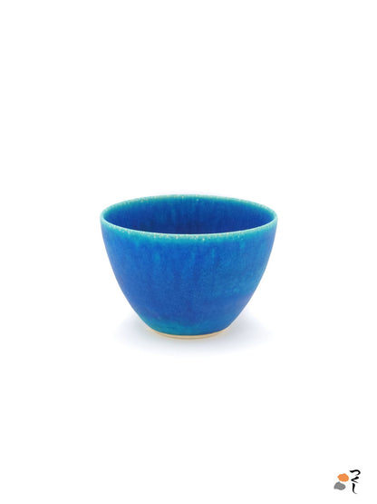 Front view of a turquoise Japanese pottery salad bowl.