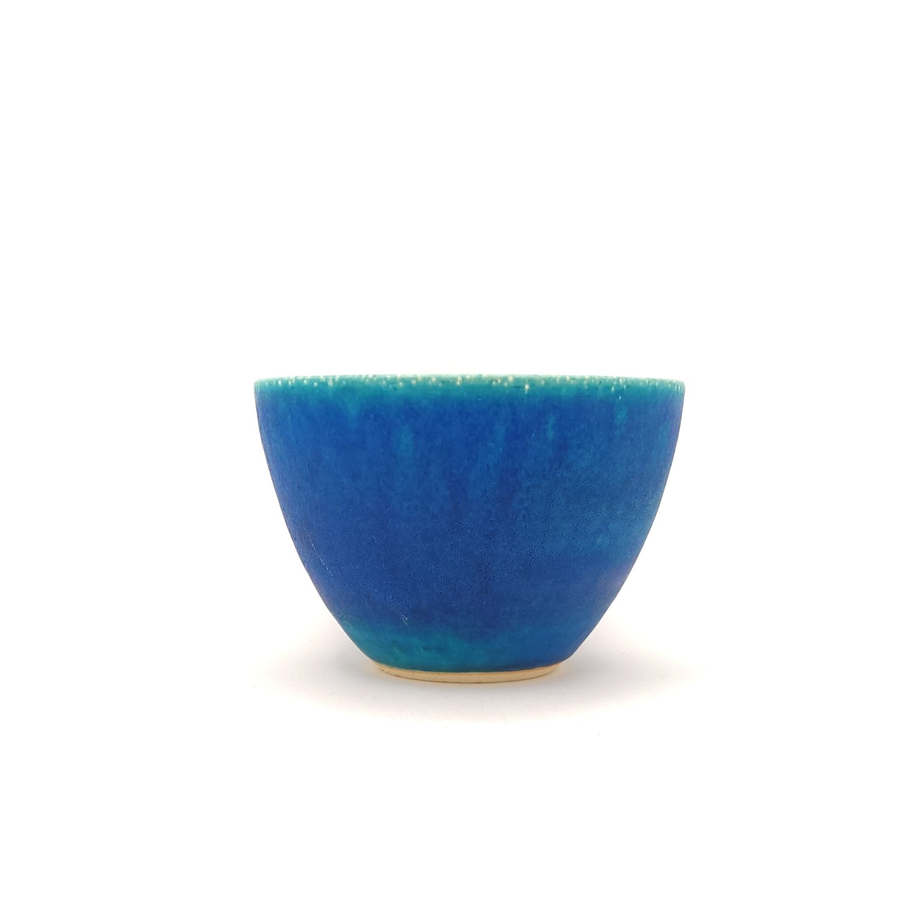 Front view of a turquoise Japanese pottery salad bowl