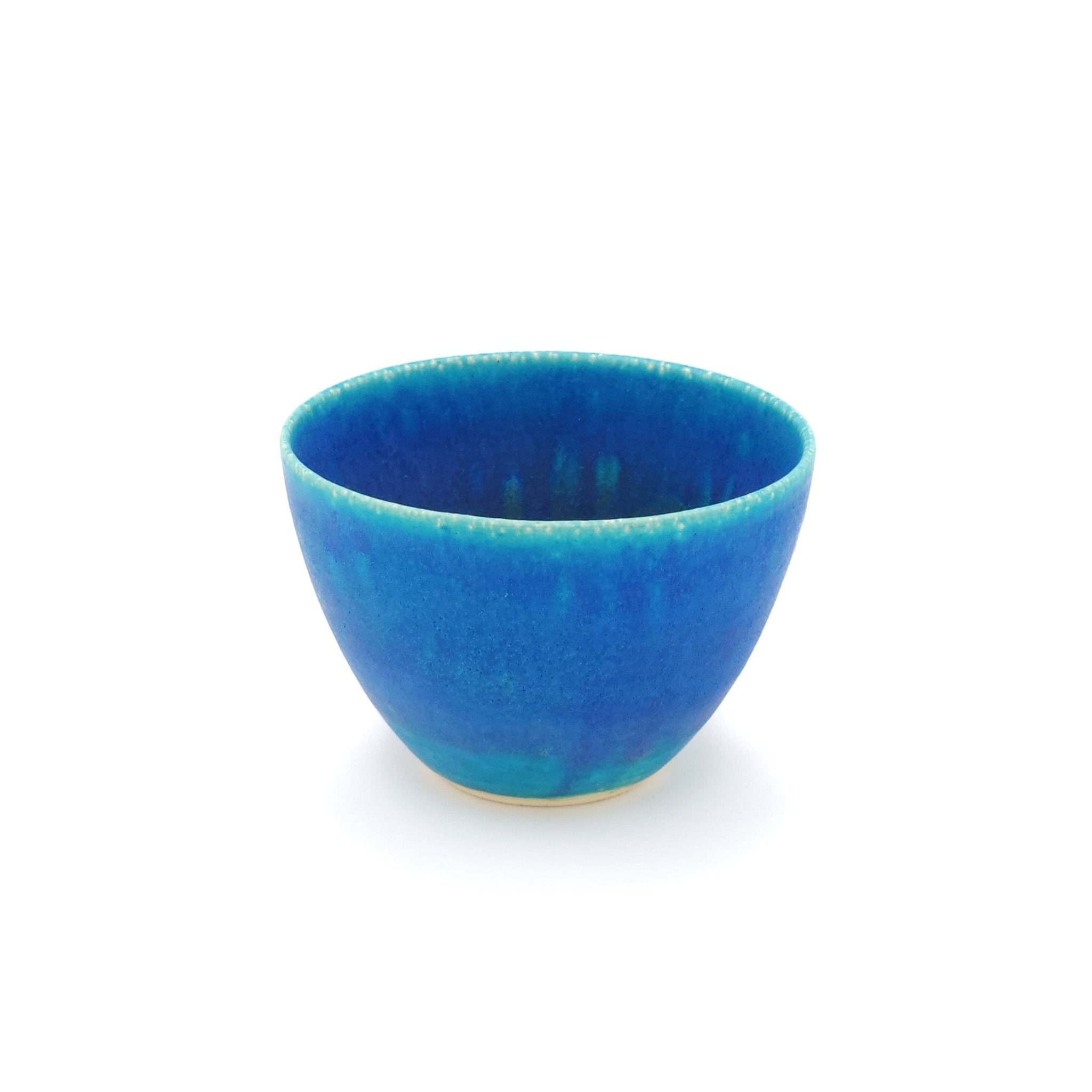 Top front view of a turquoise Japanese pottery salad bowl