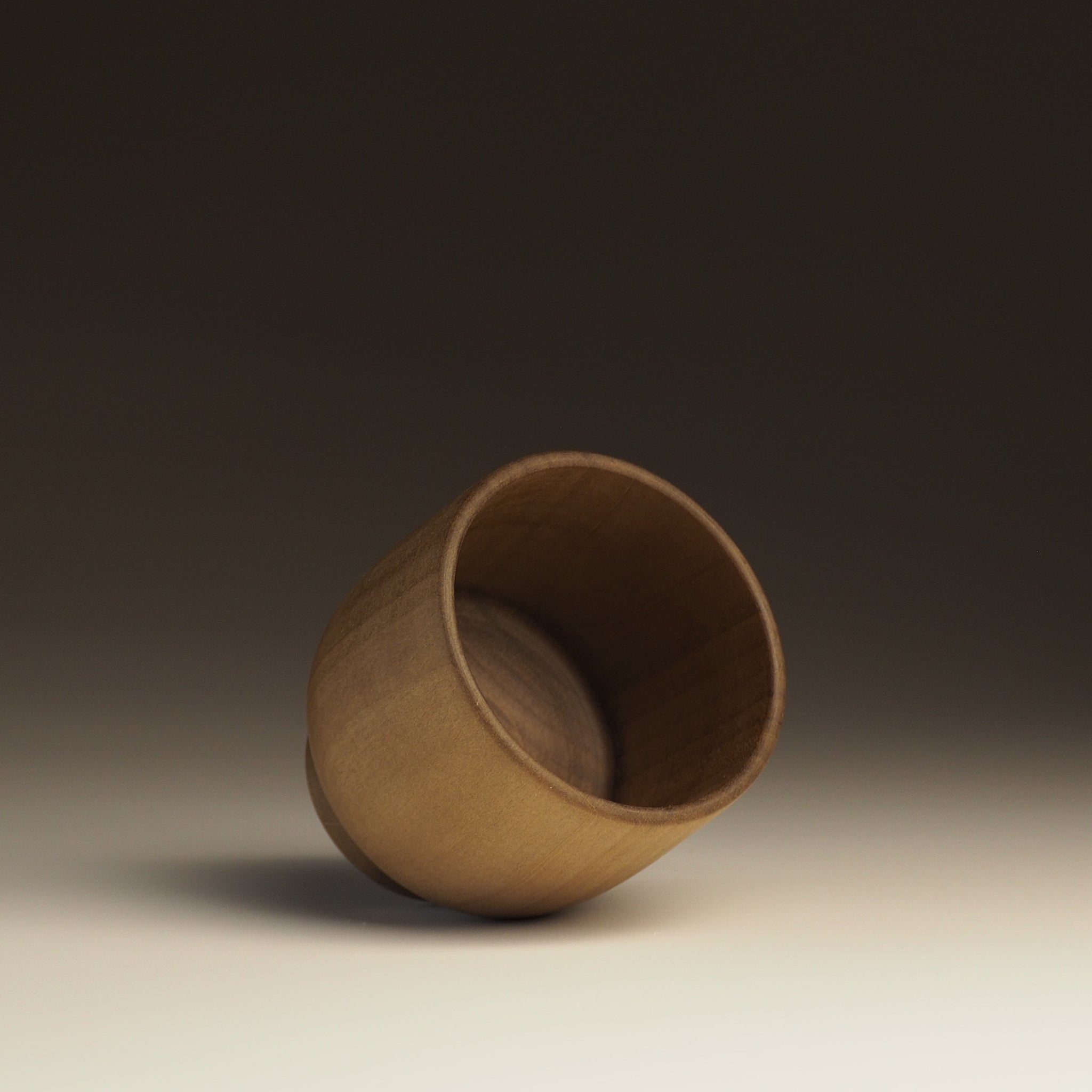 Japanese handcrafted Wooden Teacup on gradation background inside. Tsukushi
