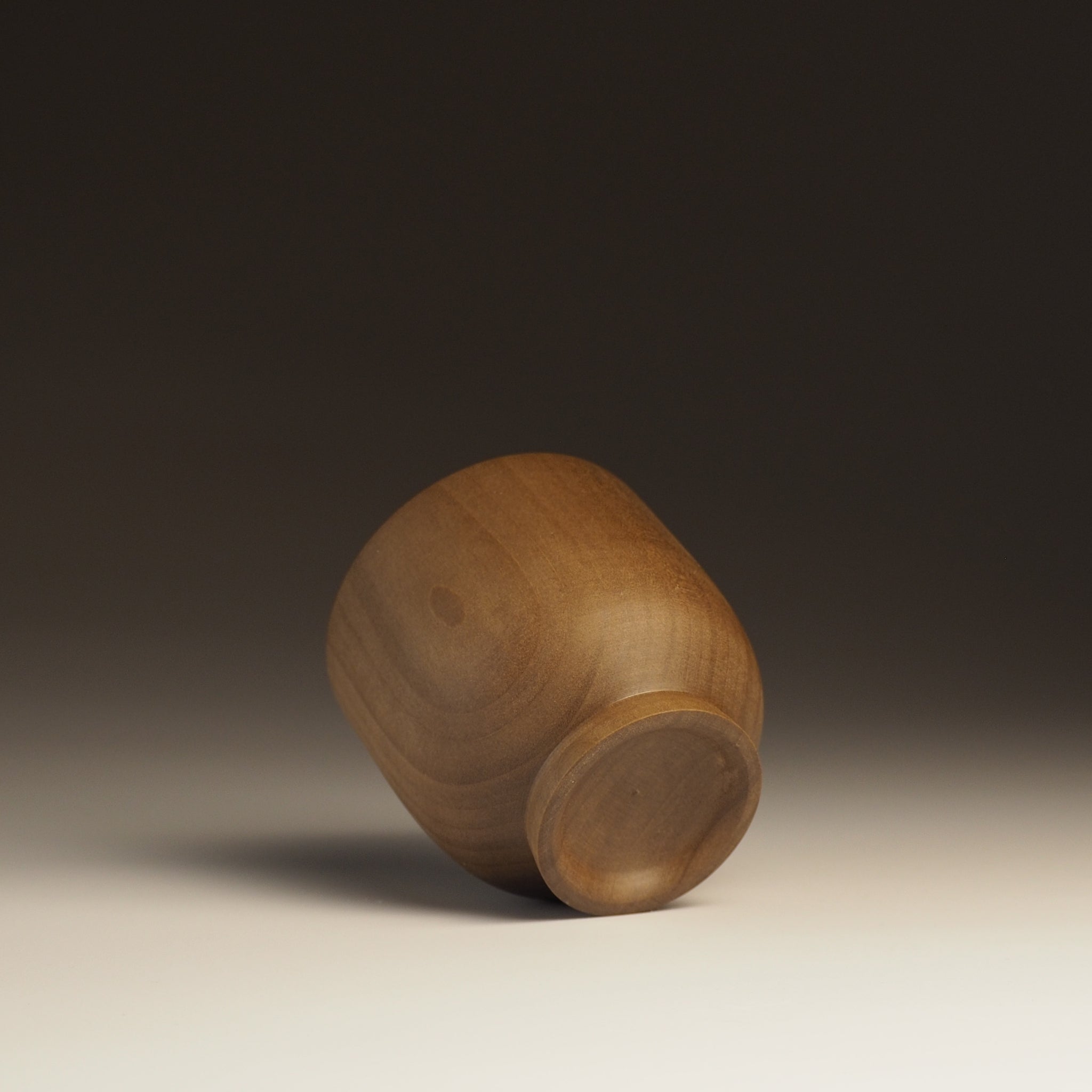 Japanese handcrafted Wooden Teacup on gradation background from back. Tsukushi