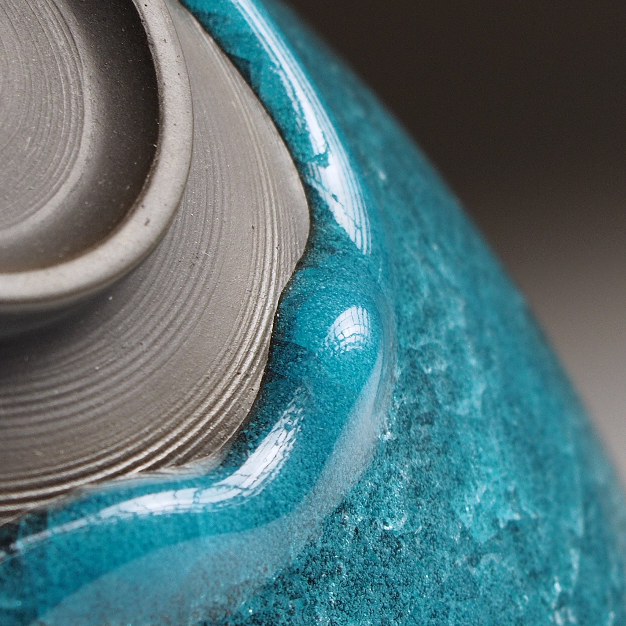Aonami waved serving bowl, unglazed foot detail showing raw clay and teal glaze pooling at the base. Usurai Pottery, Japan.