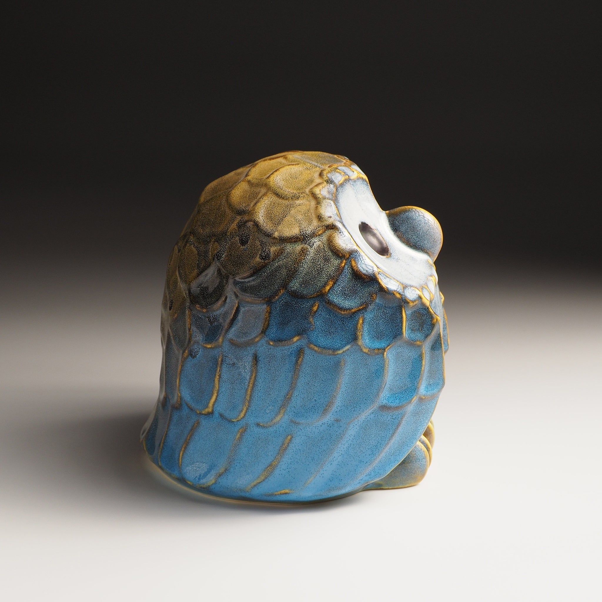 Right side view of the large Fukumori ceramic owl figurine by Kazuhiro Kojima, cerulean blue and amber Nanasai Tenmoku glaze, handcrafted in Japan, Tsukushi.