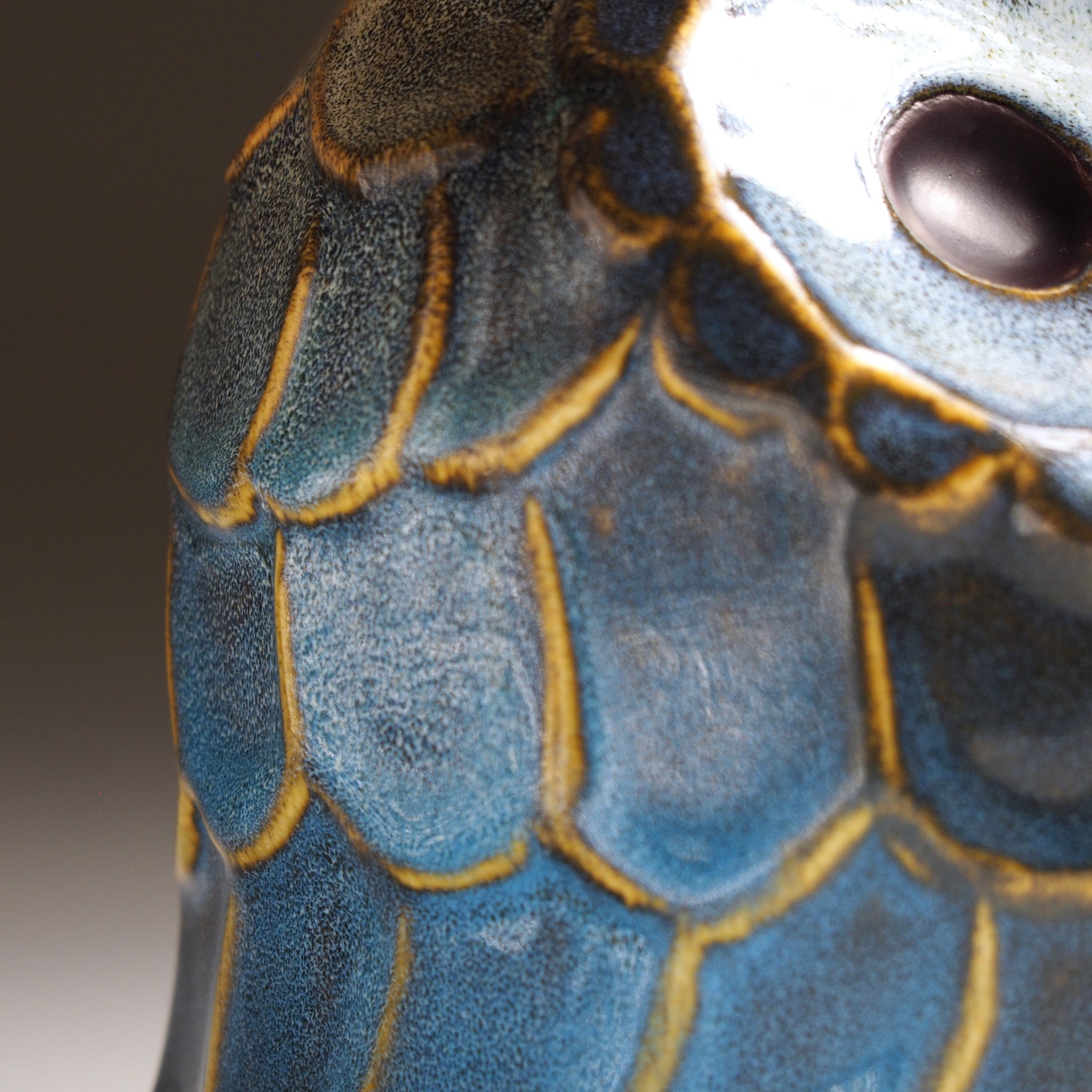 Wing and eye detail of the Fukumori medium ceramic owl figurine by Kazuhiro Kojima, cerulean Nanasai Tenmoku glaze, handcrafted in Japan, Tsukushi.