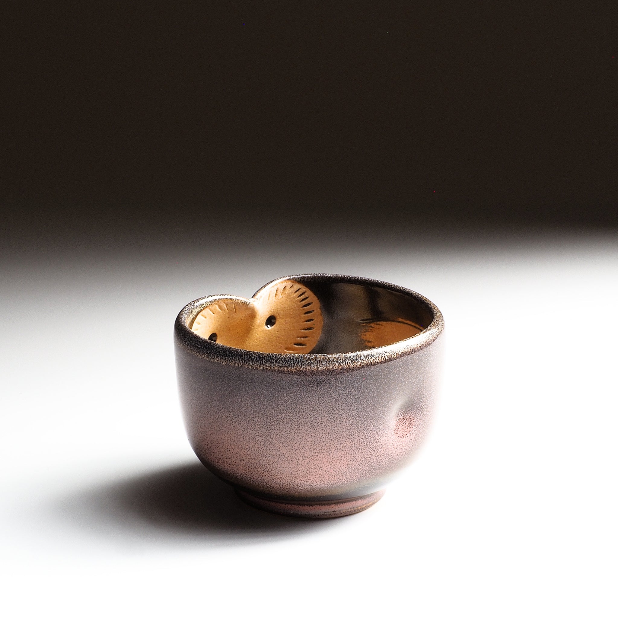 Fukuro pink ceramic teacup with owl motif on a gradient background