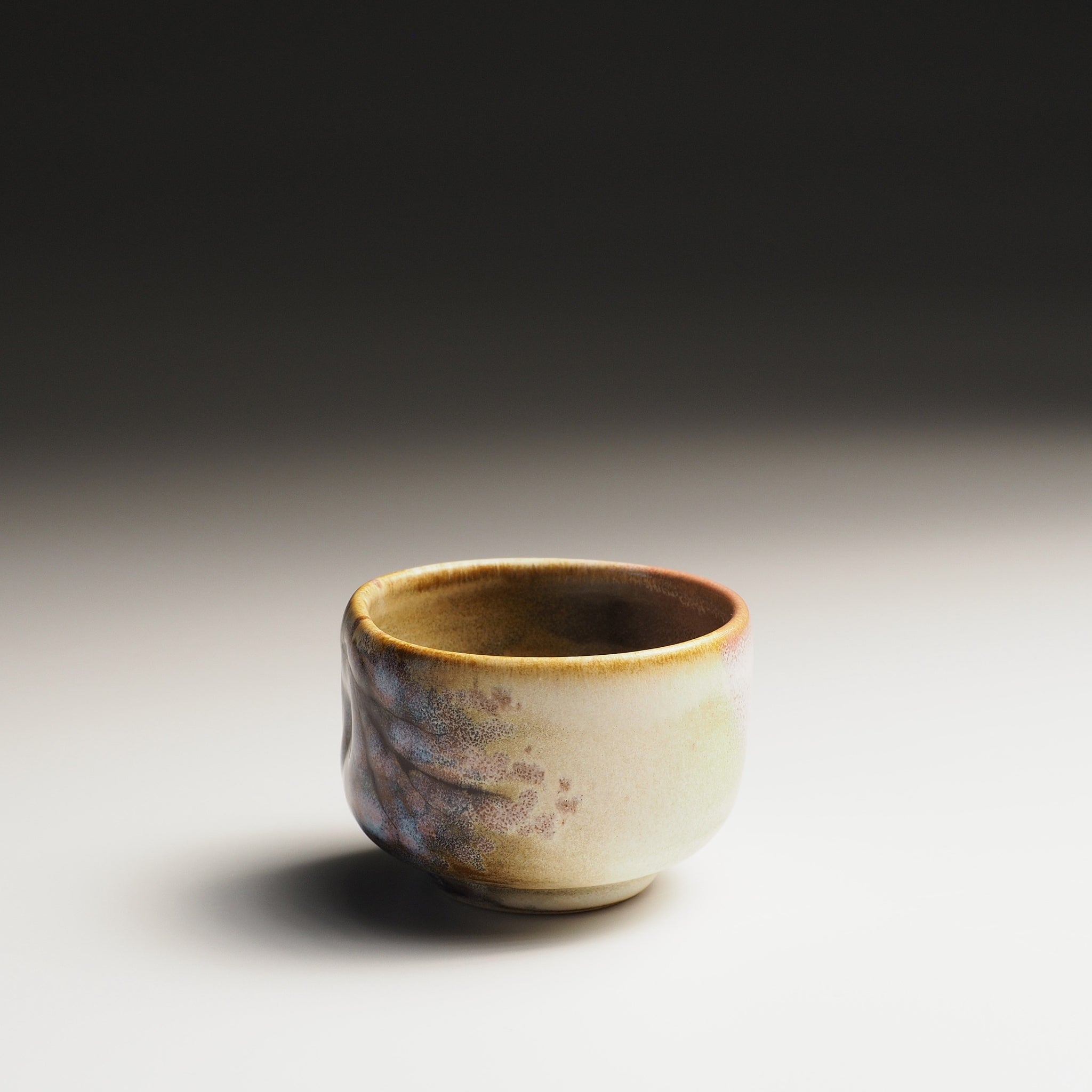 Guinomi sake cup with sakura decorations and pink shades on a gradient background