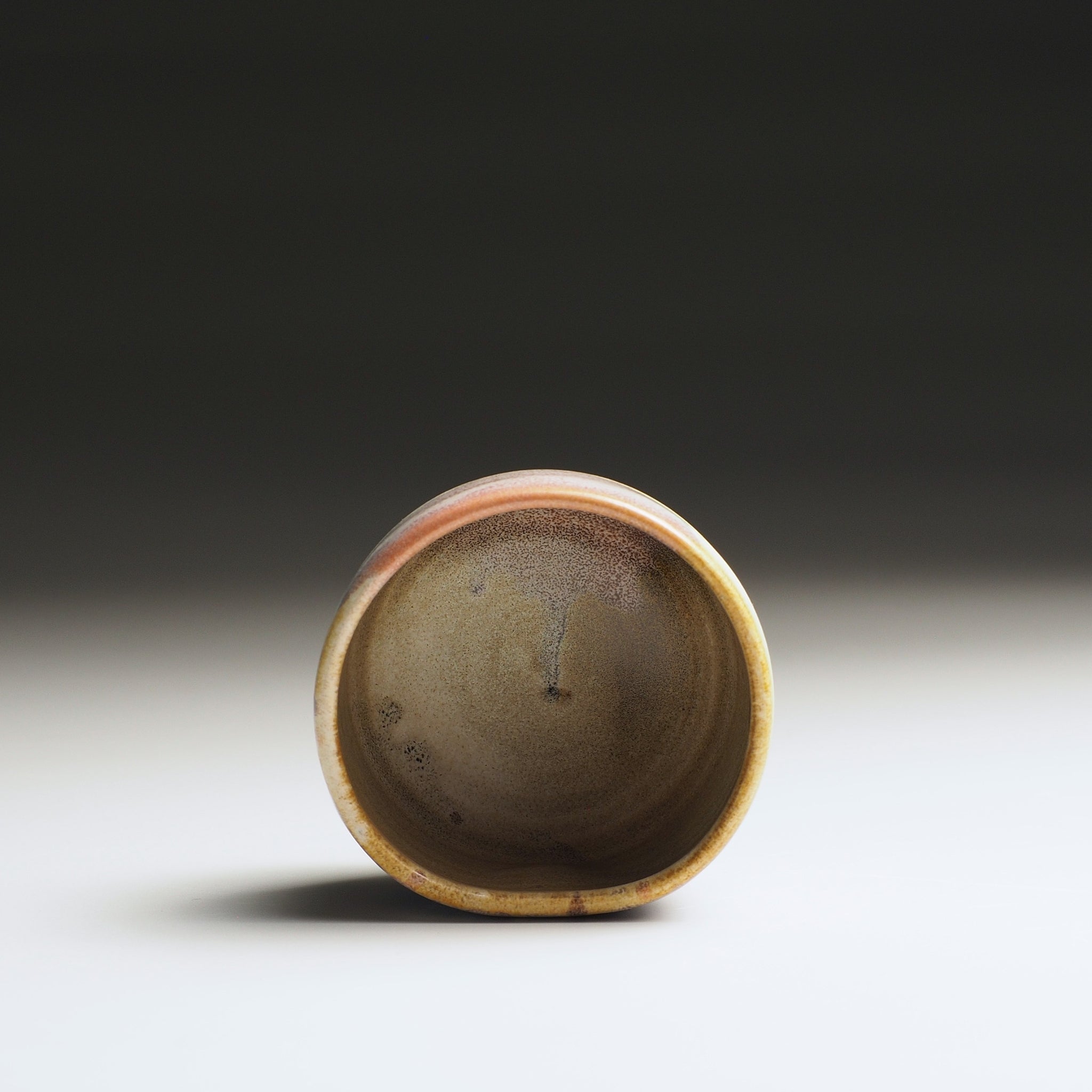 Frontal view of the interior of a Japanese guinomi sake cup.