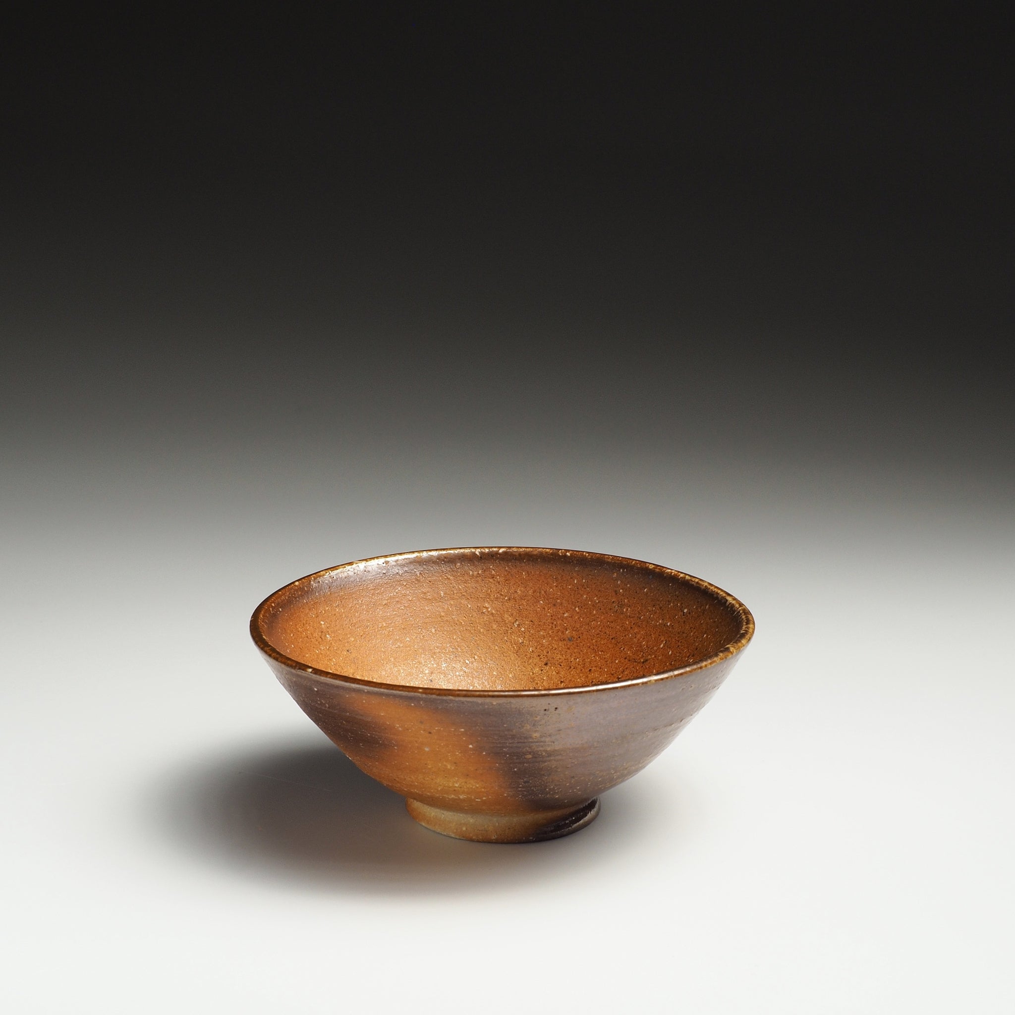Single Mizuho Shigaraki rice bowl with a warm brown interior and softly varied beige exterior.