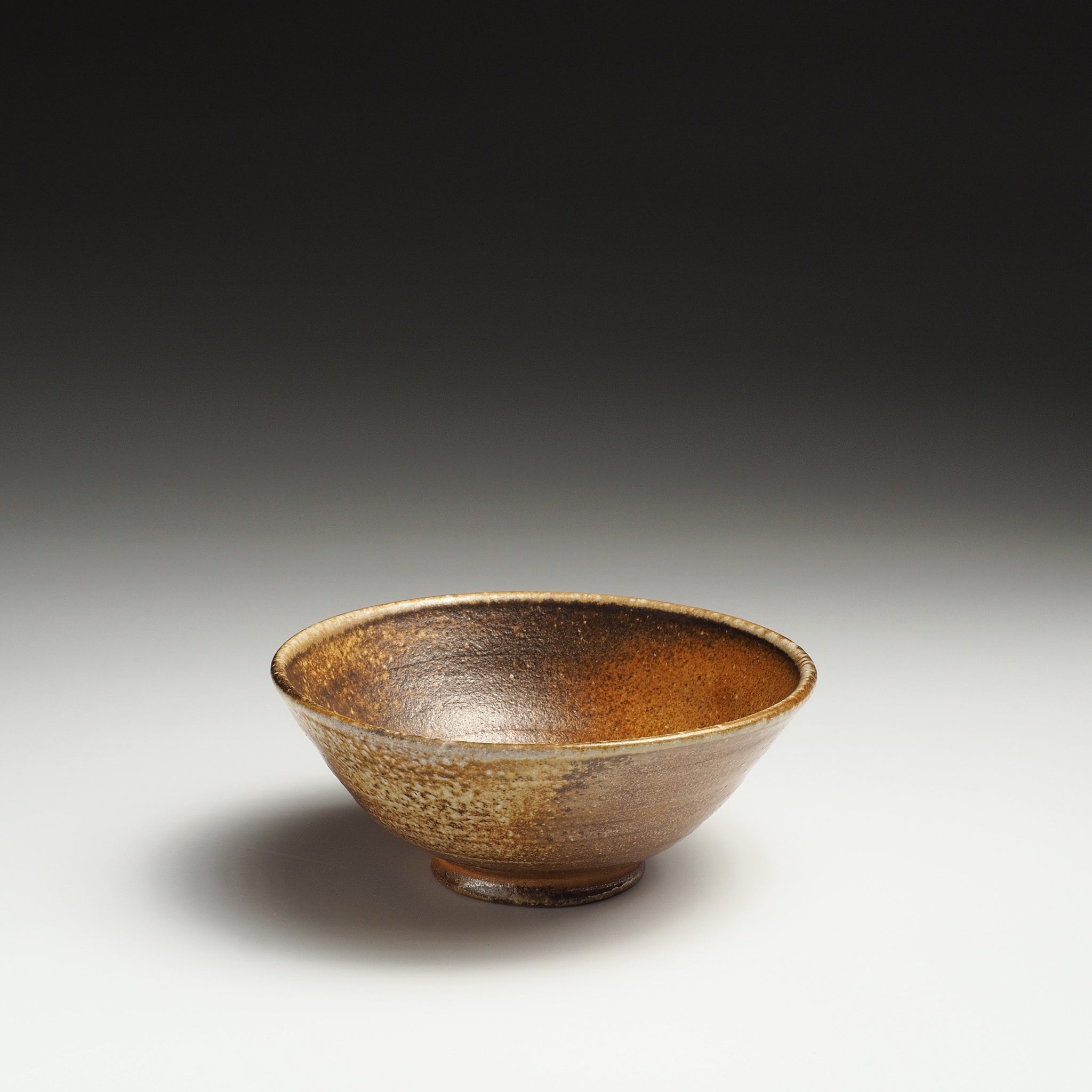 Single Mizuho Shigaraki rice bowl with a textured beige and brown ash-fired surface.