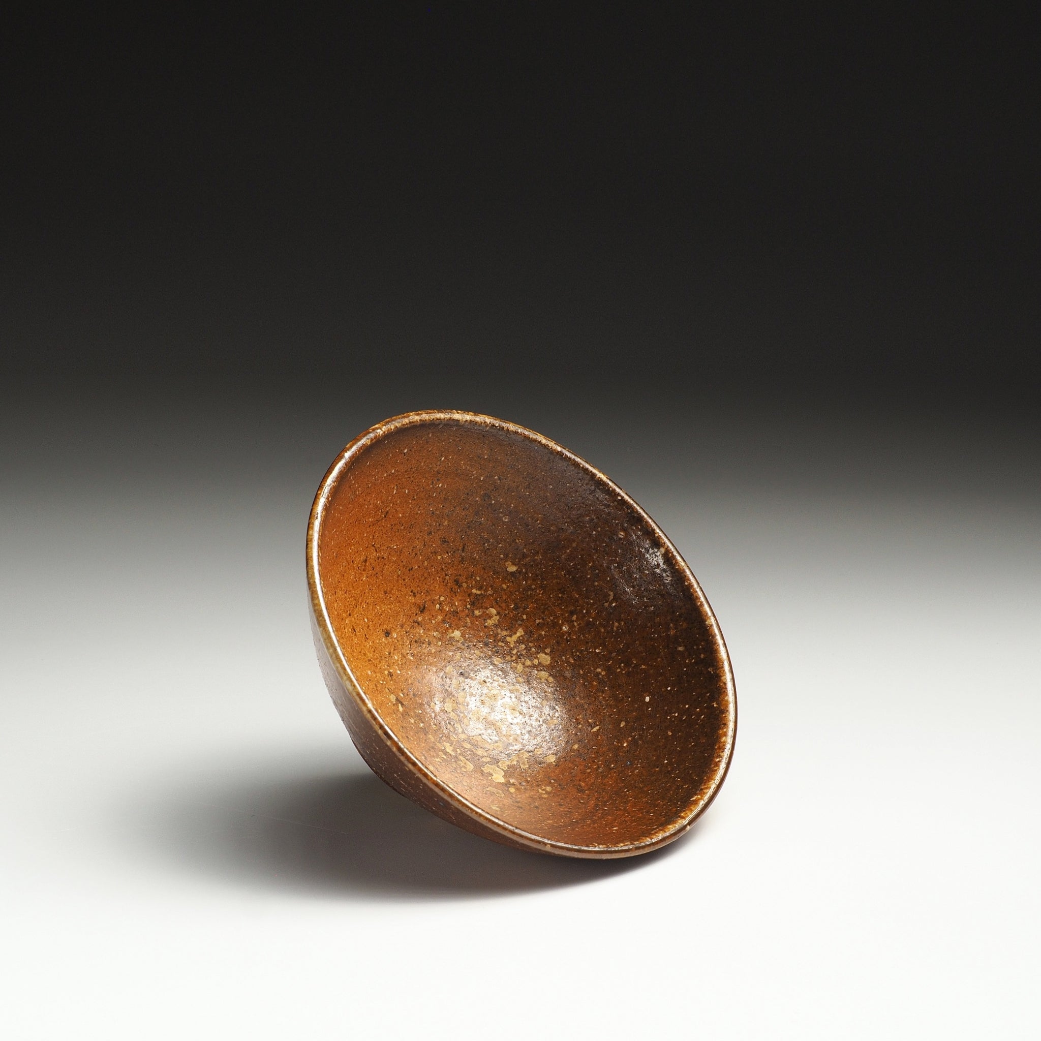 Interior view of a Mizuho Shigaraki rice bowl showing its warm brown interior and softly rounded form.