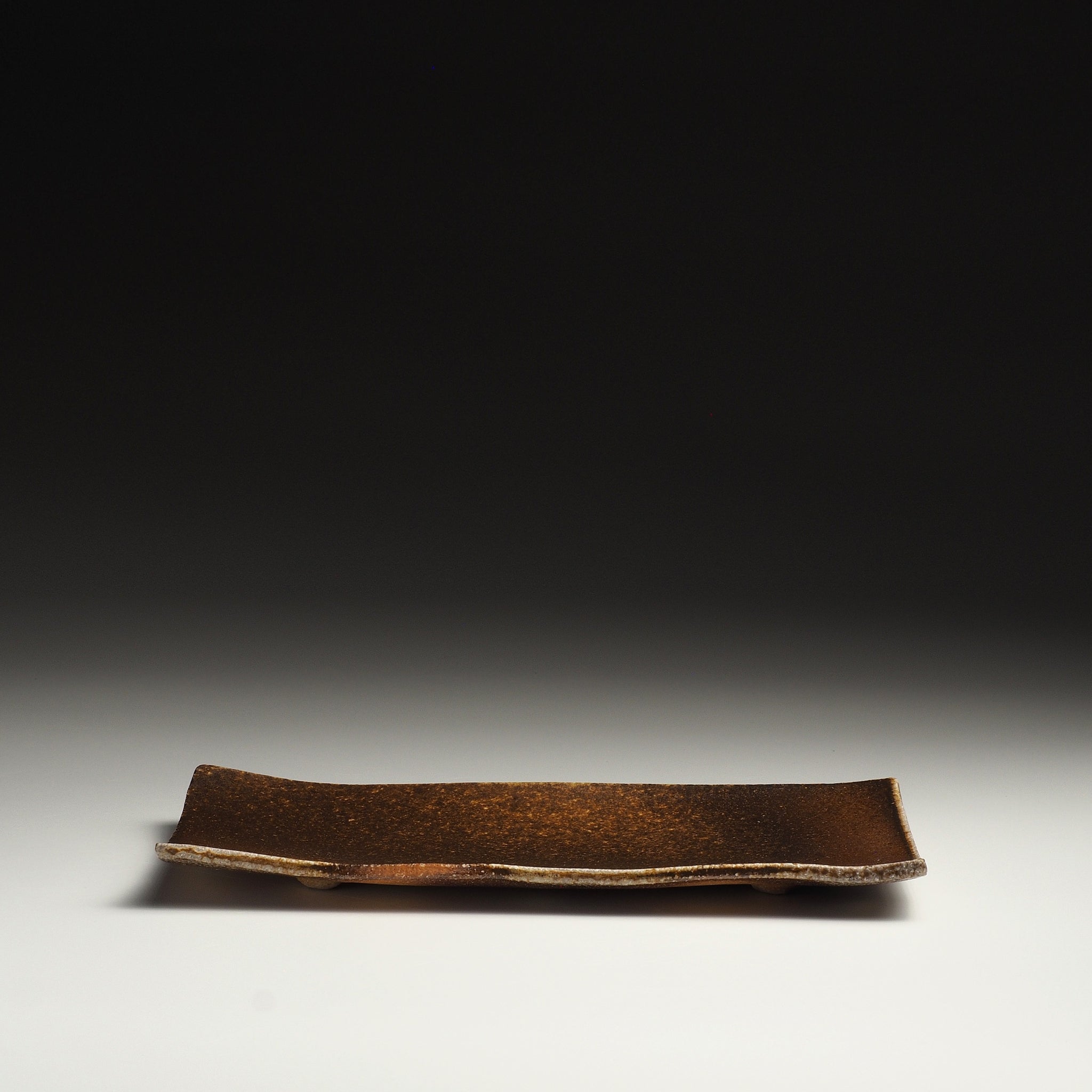 Front view of the Nagafune Shigaraki rectangular serving plate showing its broad brown surface and gently curved edges.