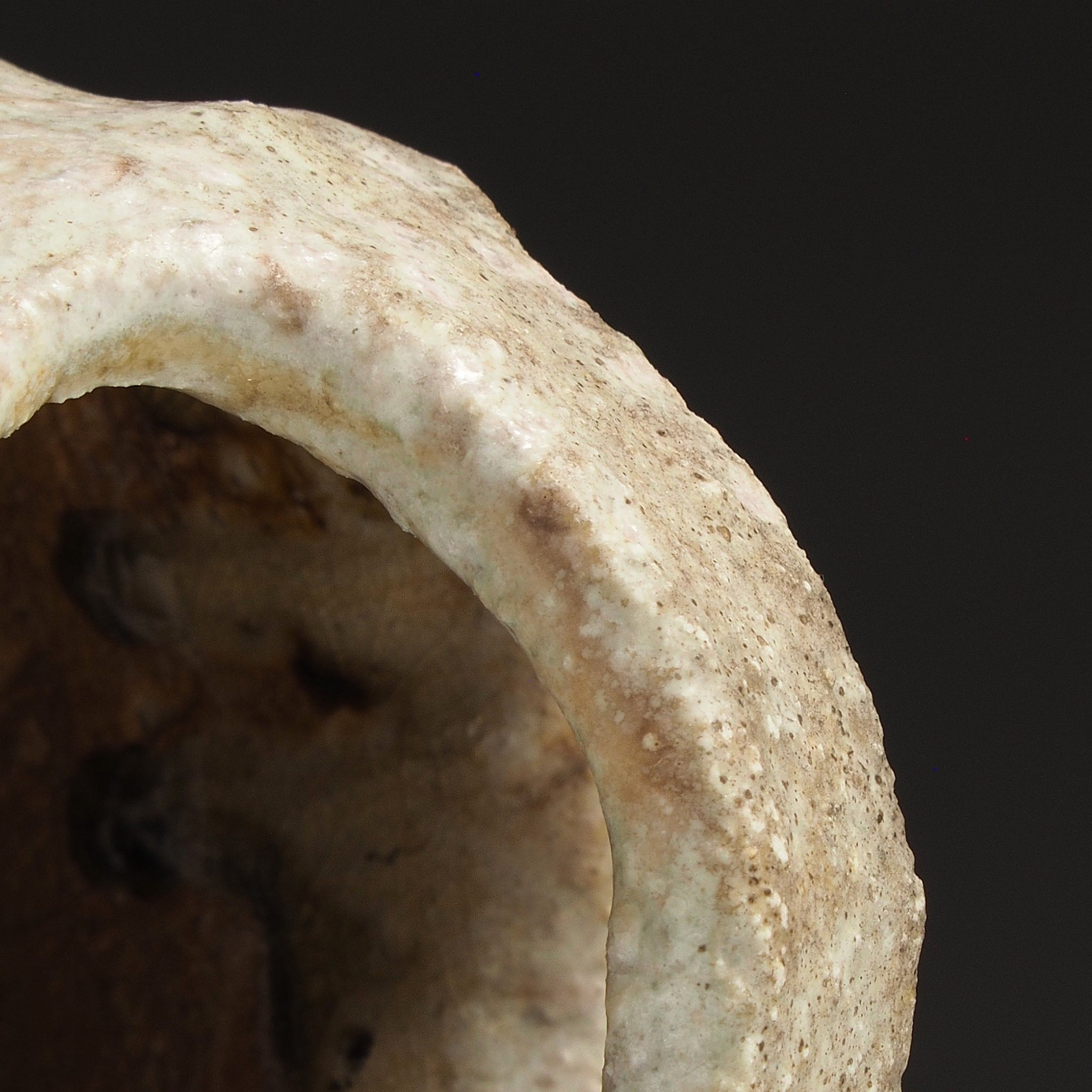 Close-up of the opening of the Setsugan Shigaraki flower vase showing its thick irregular handle and handmade texture.