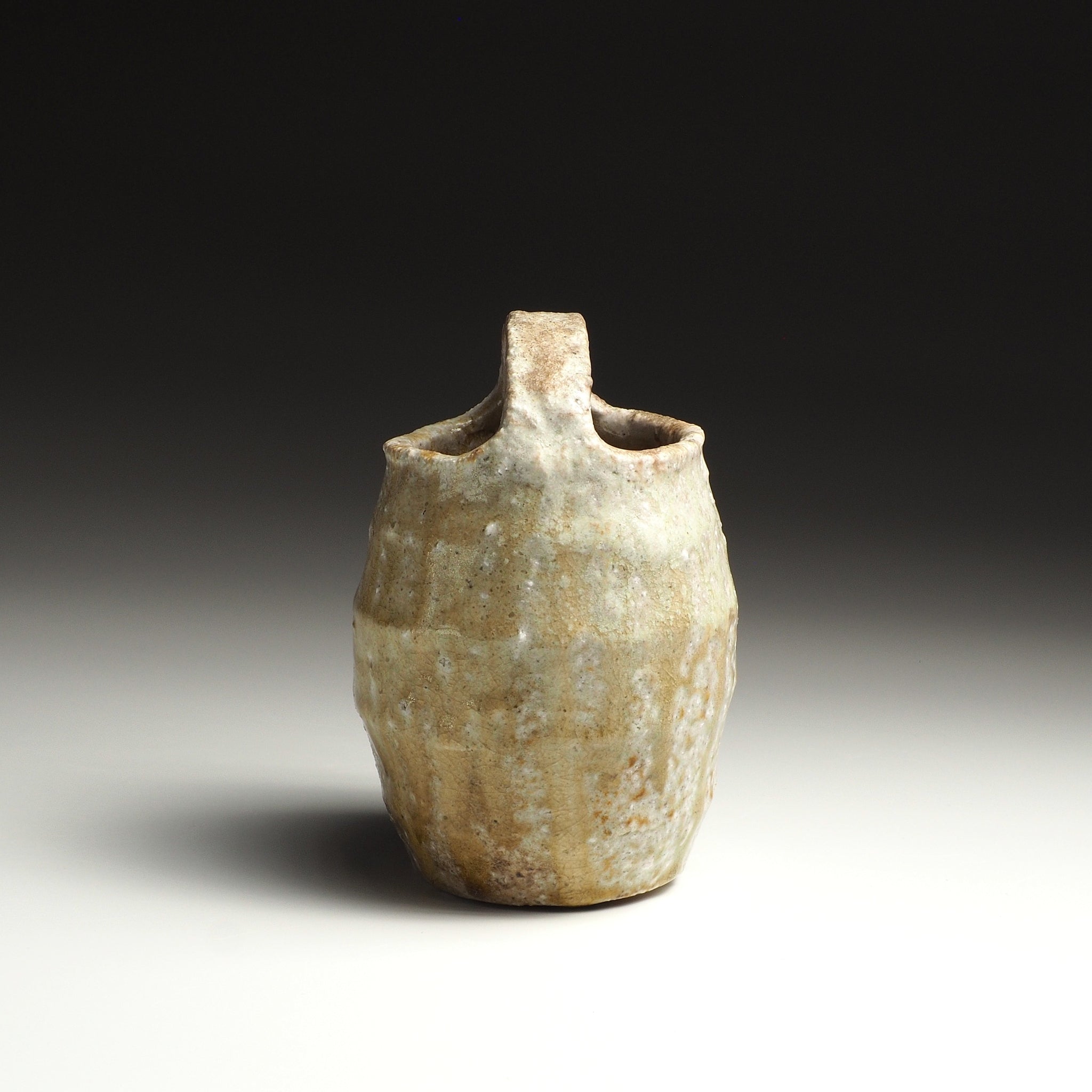 Side view of the Setsugan Shigaraki flower vase showing the upright handle and textured handmade body.