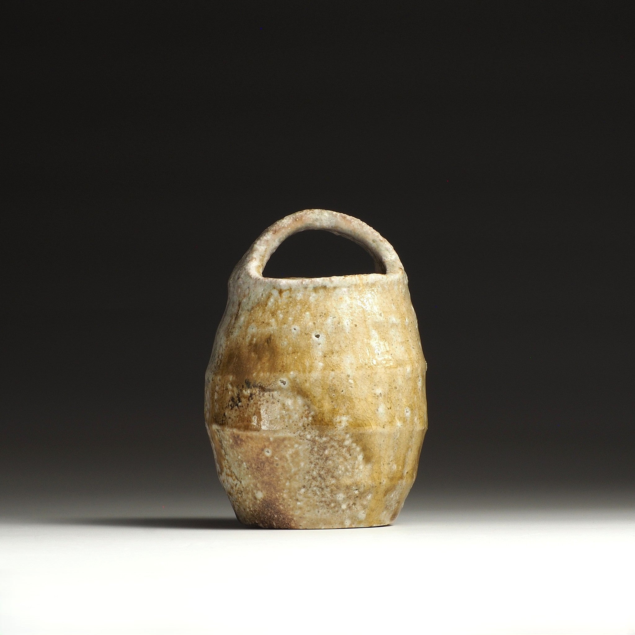 Setsugan handmade Shigaraki flower vase viewed from the opposite side, with loop handle and warm natural ash tones.