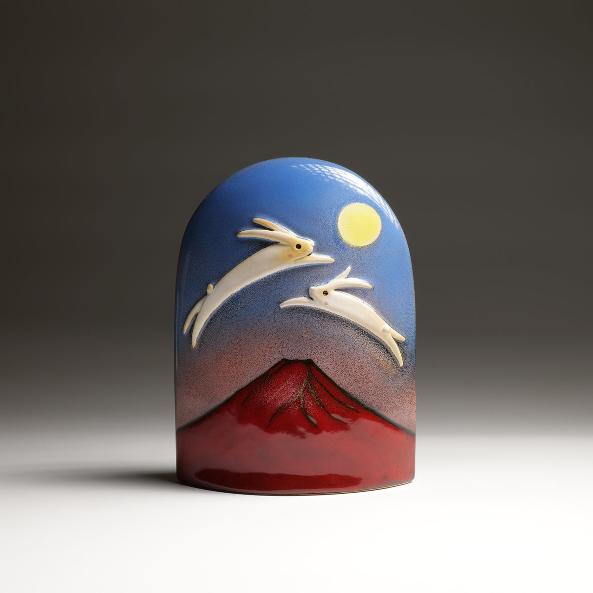 Tsukimi ceramic ornament by Kazuhiro Kojima, front view with moon, rabbits and red Mount Fuji.