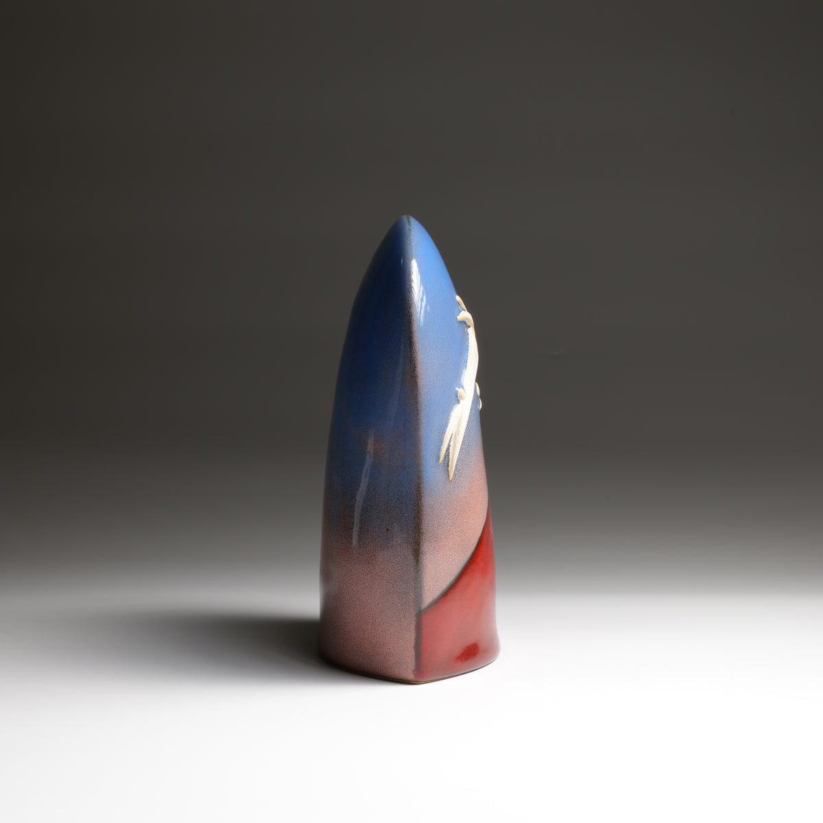 Tsukimi ceramic ornament by Kazuhiro Kojima, side profile showing the blue, white and red glazed surface.