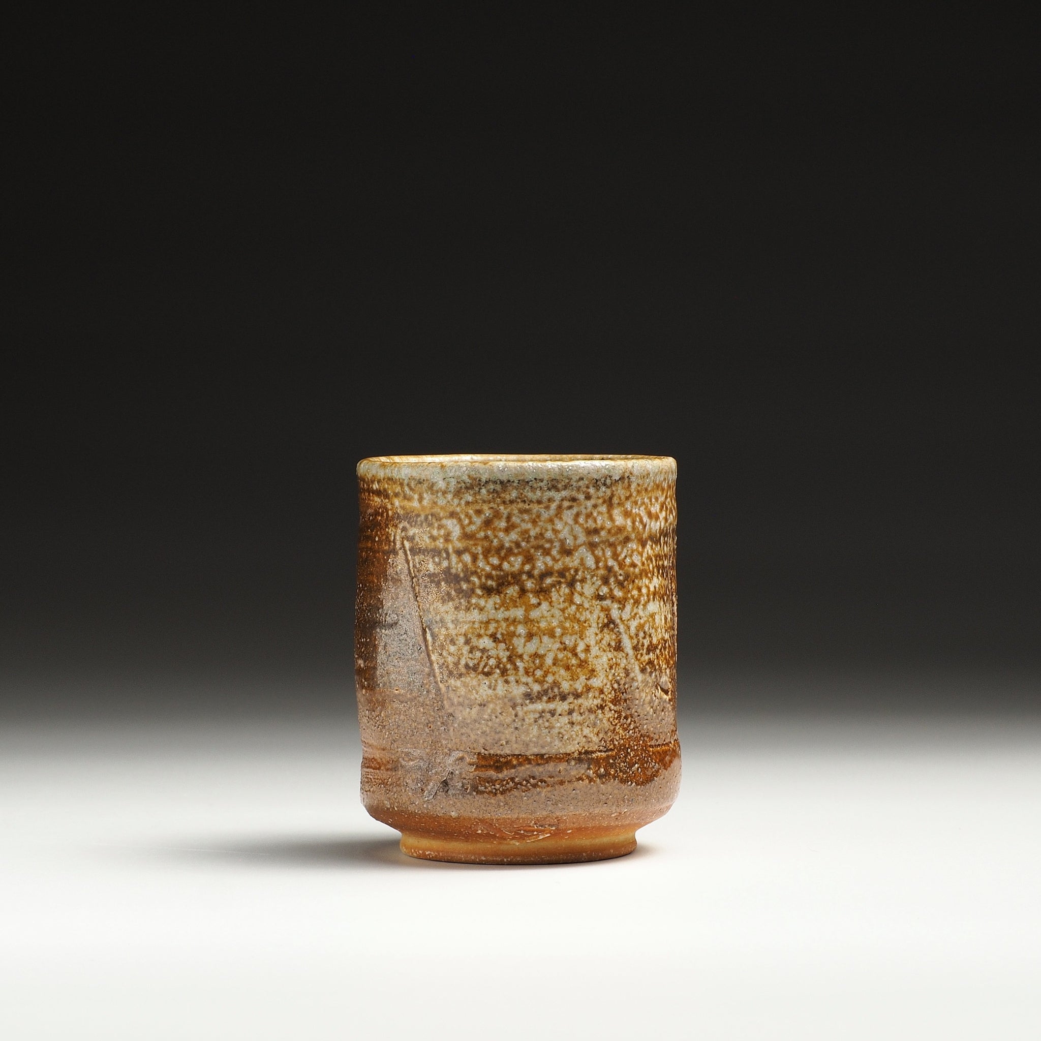 Single Yubae handmade Shigaraki yunomi showing warm orange-brown clay and pale natural glaze.