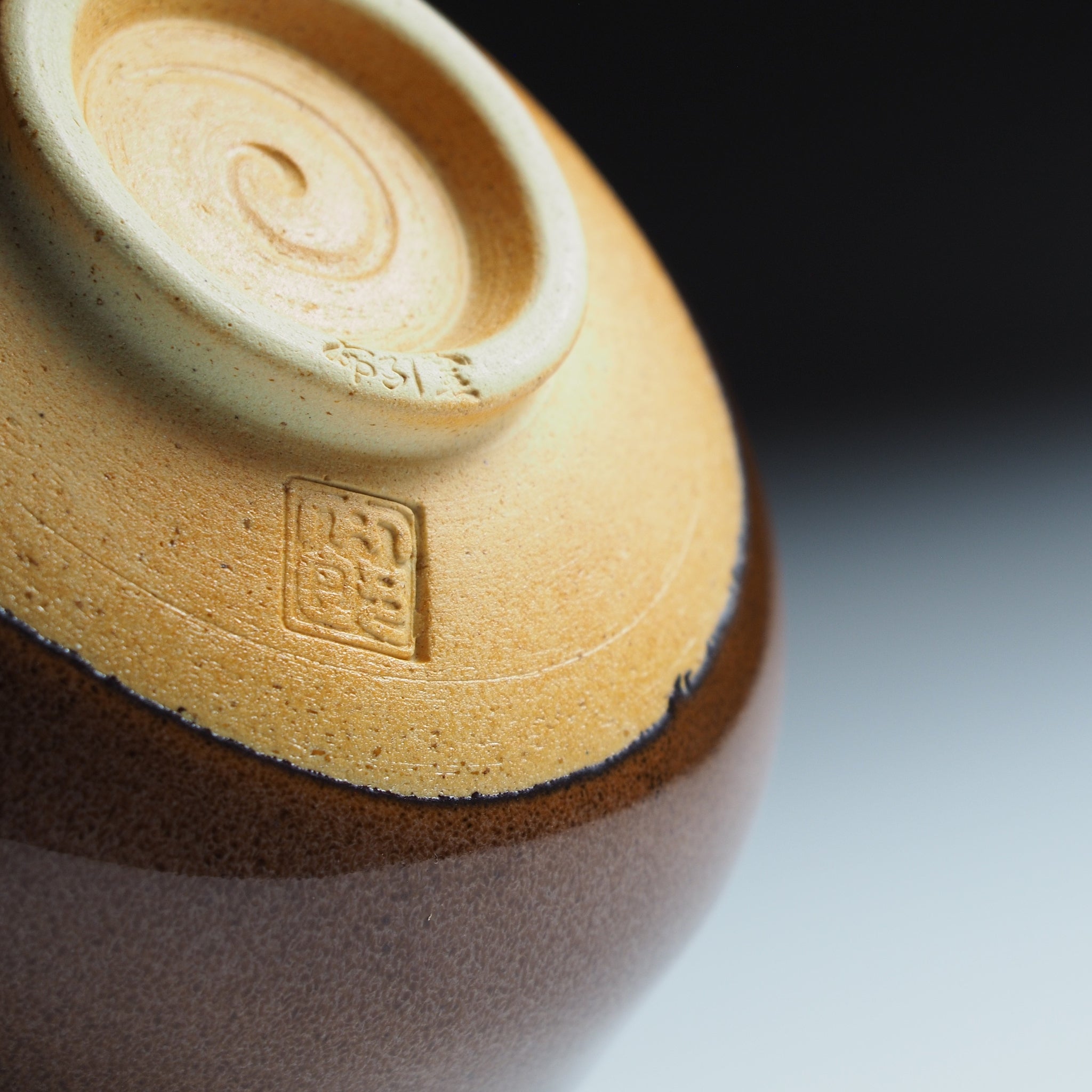 Close-up of Yūkaede matcha bowl foot ring, Taro Kojima's impressed seal on natural Shigaraki clay, Nunobiki Kiln